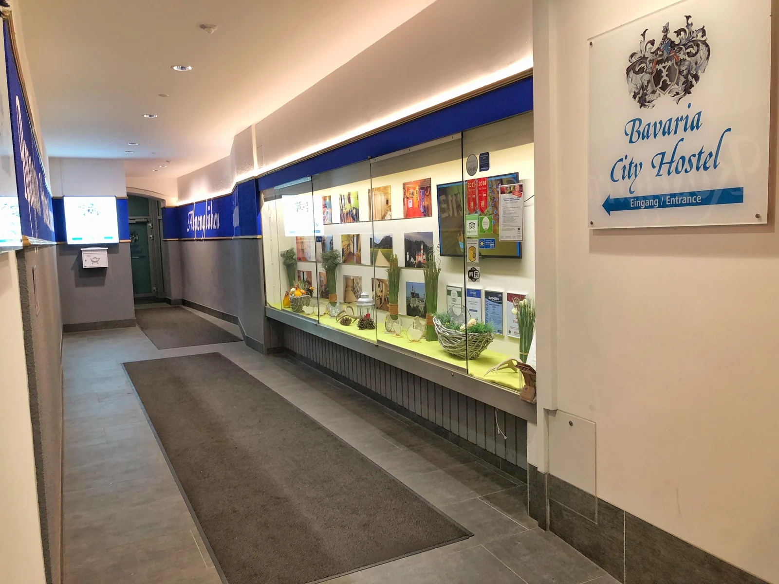 Der Durchgang zum Hosteleingang mit dem Schild Bavaria City Hostel und Schaufenster